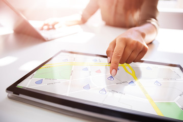 Person Using GPS Service On Digital Laptop