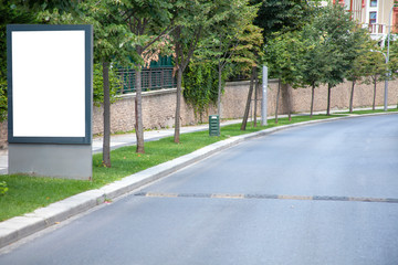 advertising board at bus stop on asphalt road