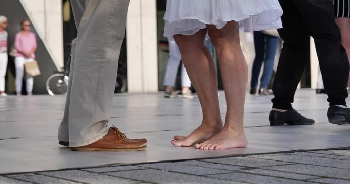  Close up view at the movement of amateur dancer's step and foot dance on the plaza outdoor dance floor with another dancer from dancing club.