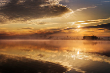 Fototapeta na wymiar Golden sunrise over a lake in Bashkiria.