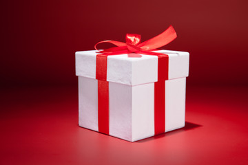 White gift box on red background. Copy spase
