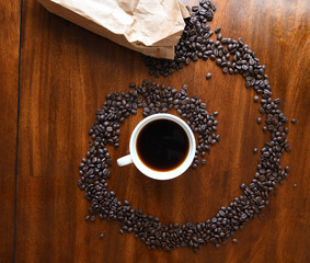 Home made coffee with coffee beans in a swirl pattern