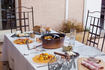 served dinner table homemade dishes cooked vegetables and appetizers white tablecloth minimum decor