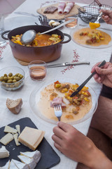 hands of elders couple having dinner together homemade food process of eating white tablecloth