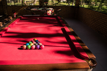 billiard balls on table in game room