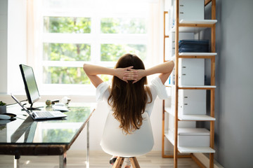 Relaxed Businesswoman Sitting In Office