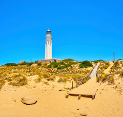 Wooden walkway going to Faro de Trafalgar Lighthouse, in The Cabo de Trafalgar Cape Natural Park....