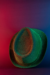 Fototapeta na wymiar Green shiny hat on a black background