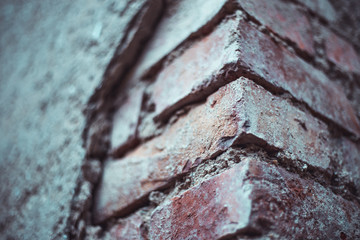 Old brown brick pillar with small cracks and rough texture - Vintage structure with weathered aspect
