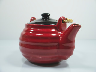 The red chinese teapot on a white background