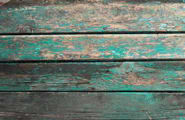 Background in the form of four horizontal wooden boards of dirty green color with peeling paint