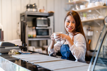 Fototapeta na wymiar Professional Asian woman Barista preparing coffee at front counter serving coffee cup to customer occupation, part-time,job or owner business working woman happy selling and making drink beverage