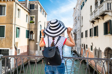 Fototapeta na wymiar Woman Looking At Houses On Canal