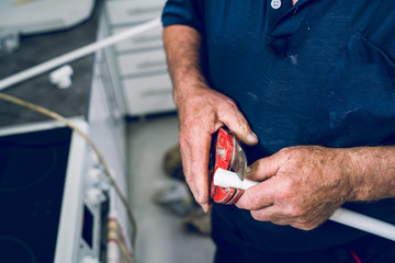 Close up on hands of plumber cutting plastic pipes cut white plumbing installation