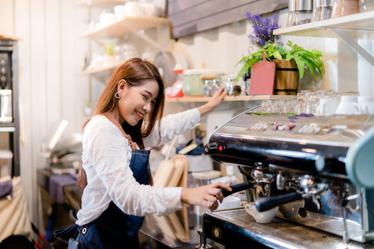 Professional Asian woman Barista preparing coffee at front counter serving coffee cup to customer occupation, part-time,job or owner business working woman happy selling and making drink beverage