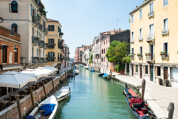 Fototapeta na wymiar Narrow Canal In Venice, Italy