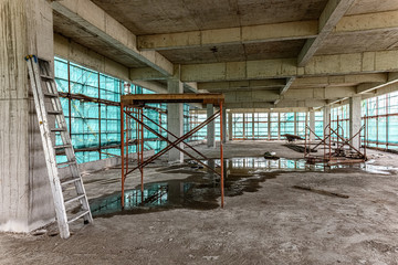 inside of an unfinshed building with protection scaffolding and netting surrounded