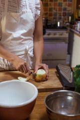Process of cutting onion woman hands in white apron rustic style