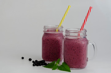 bilberry or blueberry smoothie in jar isolated on white background. Purple milkshake.