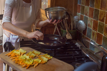 step by step process of cooking courgette flower Provence dish hands