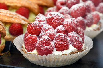 close up of red raspberry tart in bakery