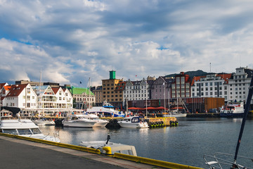 Scenic summer view with the Old Town pier architecture and boats in Bryggen - Hanseatic wharf, Bergen, Norway.