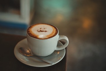 cup of coffee on wooden table