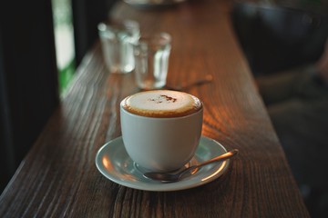 cup of coffee on wooden table