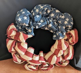 Fototapeta premium Red, white, and blue veterans wreath made of coarse burlap material