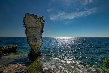 Thin clouds dot the afternoon sky over flowerpot island, Lake Huron, ON