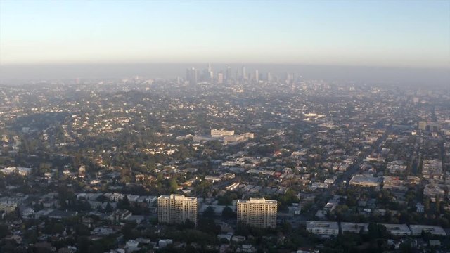 Aerial, pan, drone shot, over the city, overlooking the downtown of Los Angeles, on a sunny, summer day, in California, USA