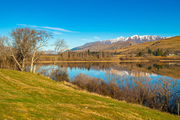 Lake Hayes on a clear blue sky, beautiful water reflection, Frankton, Lake Hayes New zealand