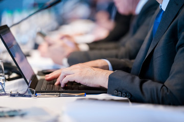 close up of business people hands using laptop computer