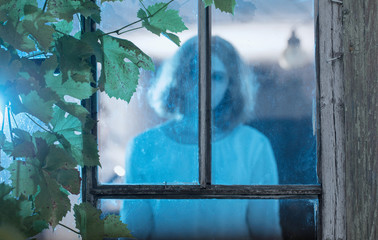 girl ghost in the old window