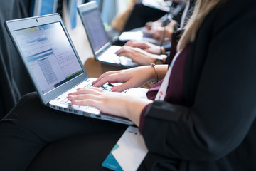 close up of business people hands using laptop computer