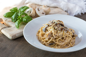 Mushroom Spaghetti Pasta and cream sauce on table, top view. Homemade italian pasta with champignon mushroom