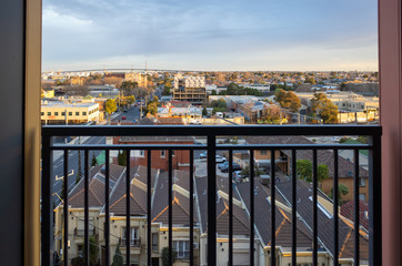 Fototapeta na wymiar Elevated view from a balcony overlooking Melbourne's metropolitan western suburbs and West Gate Bridge. Footscray, VIC Australia.