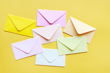 Colorful envelopes on yellow background