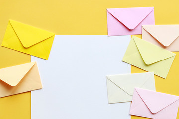 Colorful envelopes on yellow background