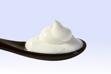 close up of skin care cosmetic beauty cream or lotion in spoon isolated on blur background with Copy space 