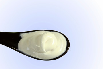 close up of skin care cosmetic beauty cream or lotion in spoon isolated on blur background with Copy space 