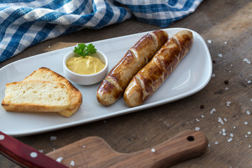 Grilled sausages. Closeup of sausage on the grill. Home-made Sausages. Bavarian sausages