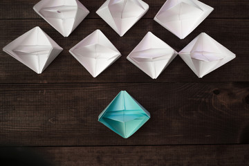 Origami boats on wooden table