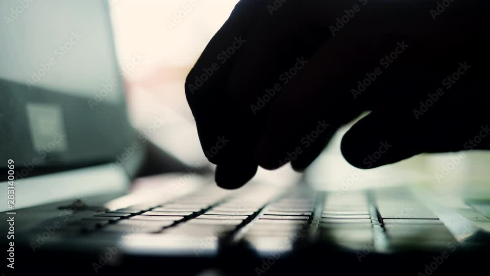 Aufkleber silhouette of hands typing on computer keyboard, business man working on laptop pc in slow motion