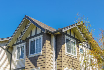 Roof of new townhouses on blue sky background
