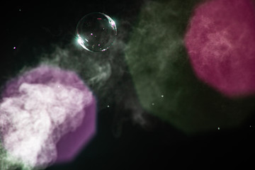 Steam jet and soap bubble with purple and magenta bokeh is close