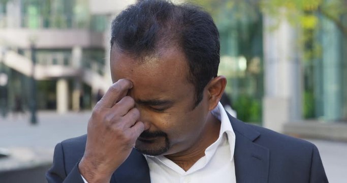 Business man thinks hard to remember a point for the camera - slow motion - shot on RED
