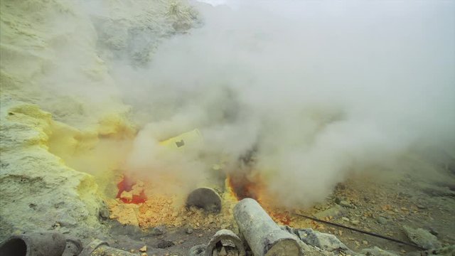 Close view of heavy yellow fumes from burning sulphur at Ijen volcano in East Java, Indonesia. Morning