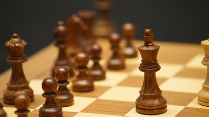 chess pieces on board leaded by black king