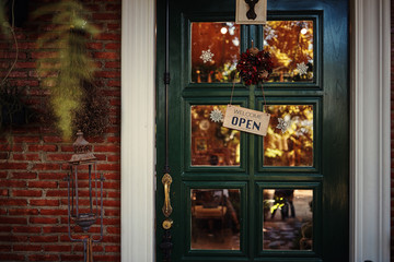 Green vintage door with hanging wooden label